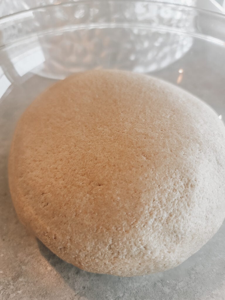 Flatten the dough and do a stretch and fold in the corners of the dough. Shape it into a ball. Cover and let rest for 20 minutes. Repeat this process an additional time.