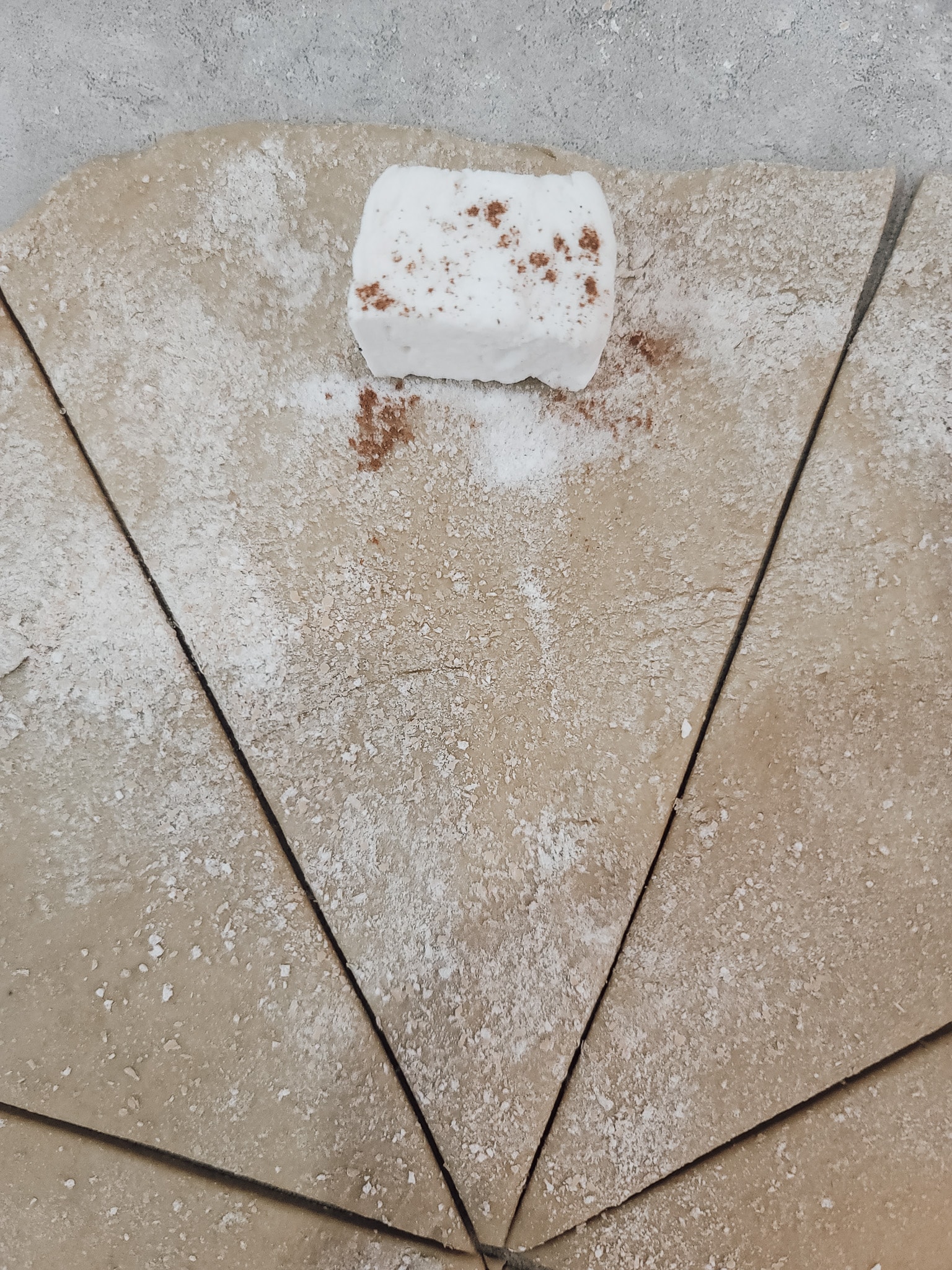 Place a Max Mellows Marshmellow on the thicker end of each triangle. Optional - sprinkle with Gentle Sweet and cinnamon. Roll up each triangular dough piece into a crescent shape and place it on a parchment or silicon-lined baking sheet. Cover with a tea towel.  homemade resurrection rolls
