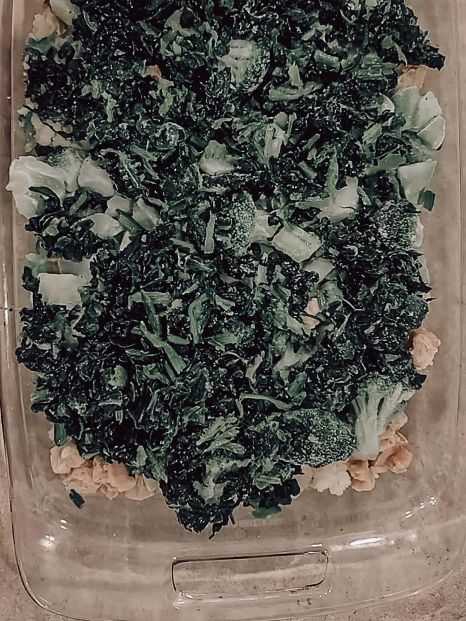 Continue layering the broccoli, riced cauliflower, and spinach.
