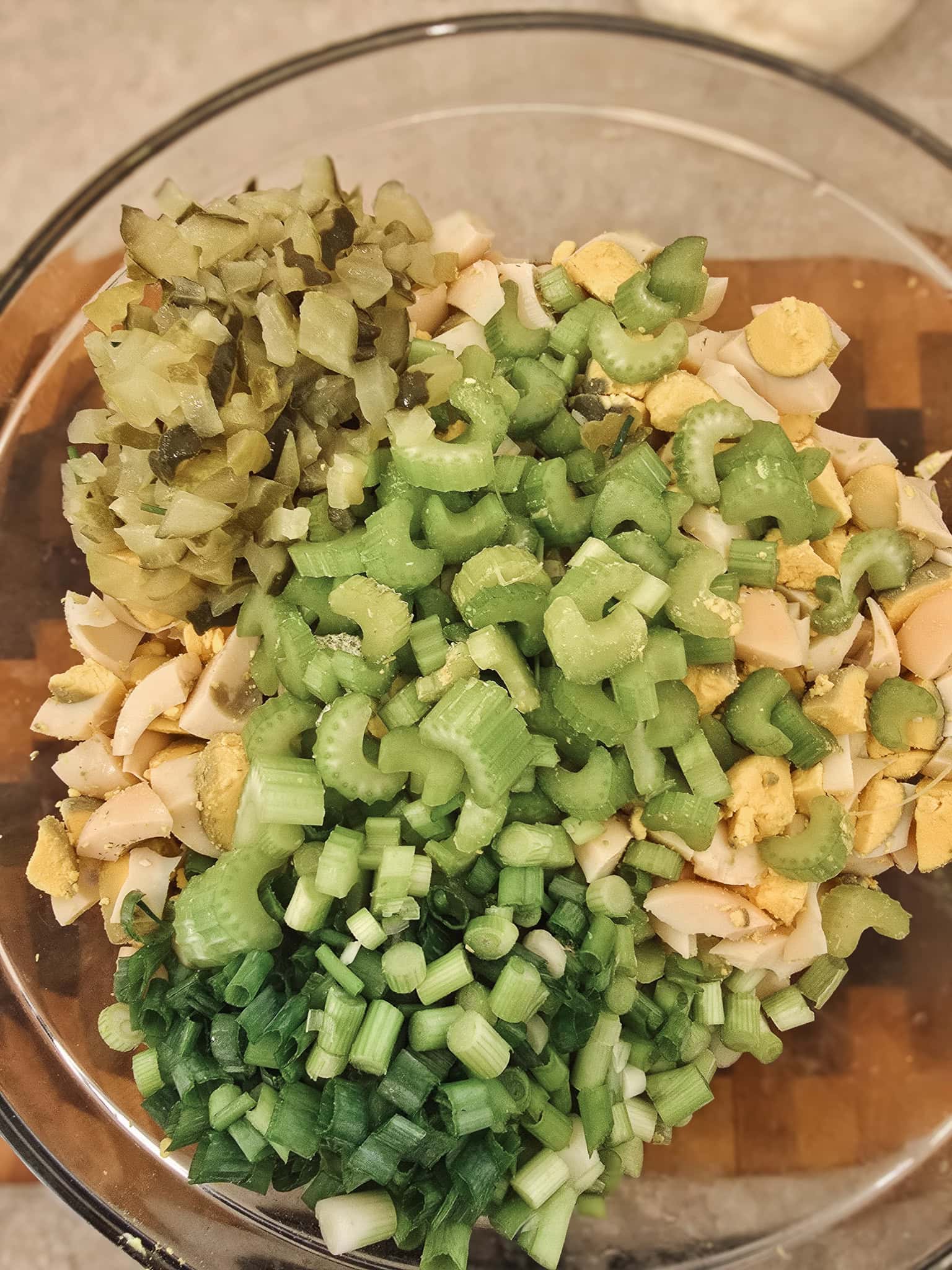 basic egg salad recipe - Step 1: Chop eggs, green onions, celery, and pickles. Place in a large bowl. 