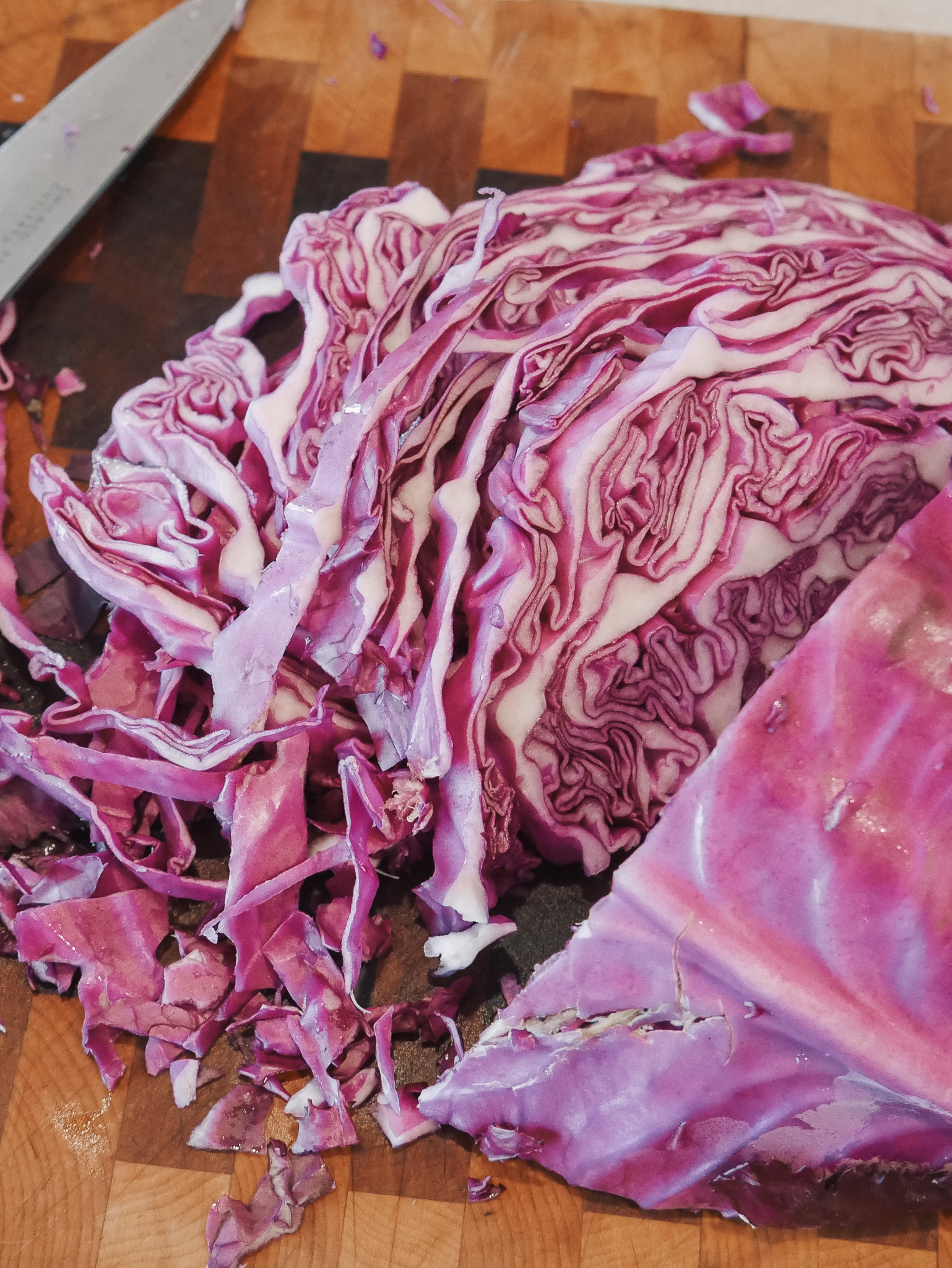 Classic Lacto-Fermented Sauerkraut - Quarter the cabbage, remove the core, and finely slice or shred it.