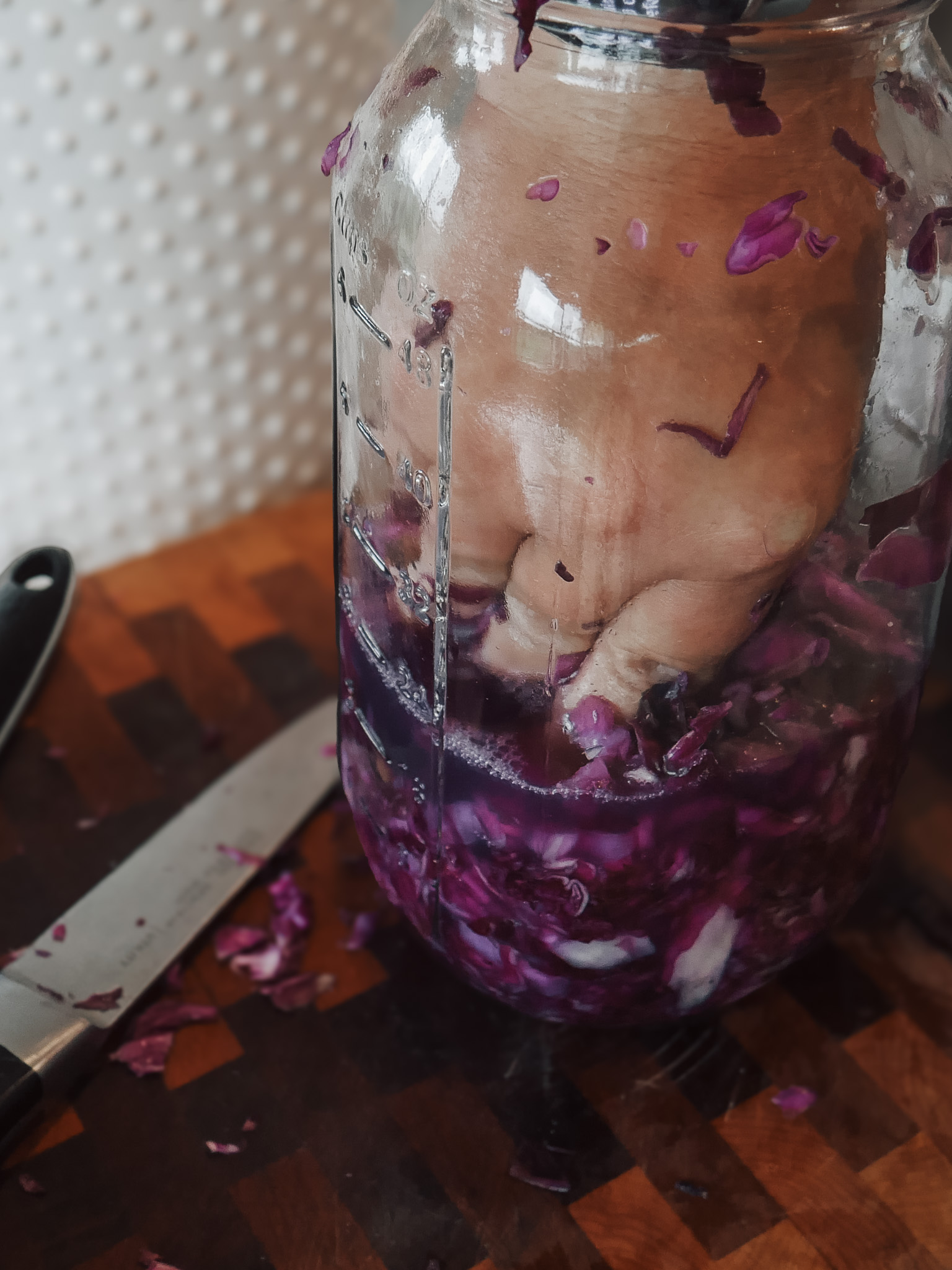 Classic Lacto-Fermented Sauerkraut - Pack the cabbage tightly into a clean glass jar, pressing firmly after each handful. I like using wide-mouth mason jars because they're easy to fill and clean.